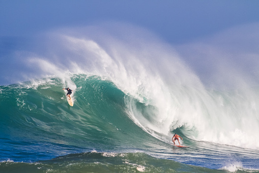 November 24, 2023. Waimea, Hawaii. Surfers bravely ride the big waves at Waimea.