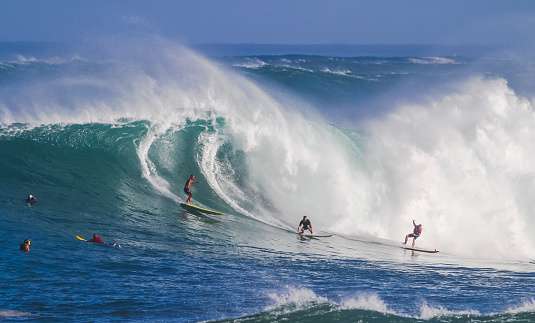 Surfer on orange surfboard riding in barrel on tropical green wave, Mentawai Islands, Indonesia