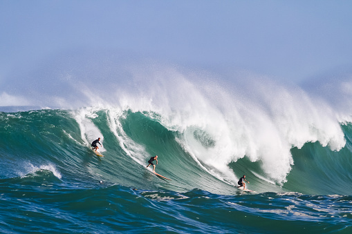 November 24, 2023. Waimea, Hawaii. Surfers bravely ride the big waves at Waimea.