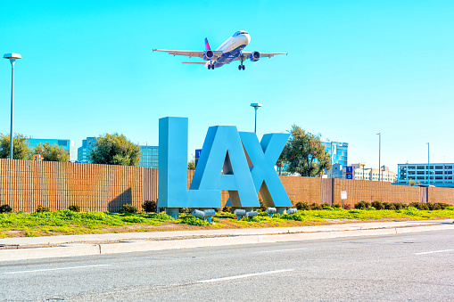 Los Angeles, California - February 1, 2023: Delta Airlines aircraft in mid-flight, soaring above the iconic LAX sign at Los Angeles International Airport