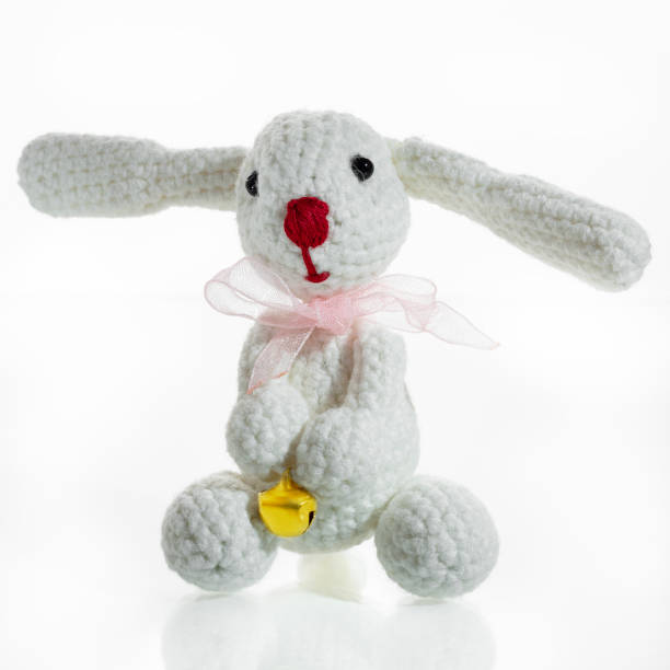 istock Knitted toy white bunny on a white background 1886749465