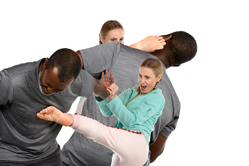 Same martial artists practicing self defense in causal clothing.