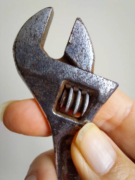 istock Crescent wrench held in woman's hand 1886759411