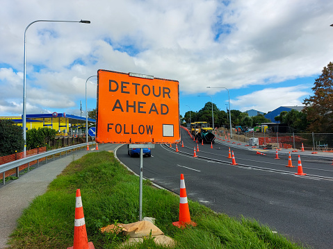 Detour ahead road sign, on a suburban road in Auckland, before road-works.