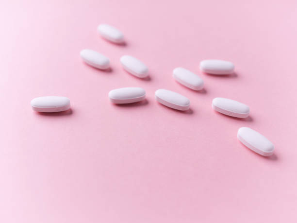 istock White tablets on bright paper background. Soft focus. Close up. Copy space. 1886769263