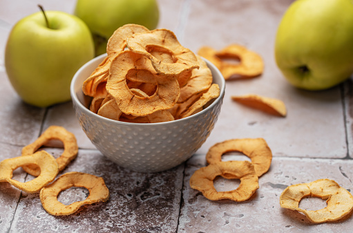 Dried apple chips. Dehydrated apples. Homemade dried organic apple sliced.