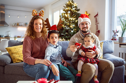 Caucasian family, parents with son and daughter together celebrating an Christmas or New Year