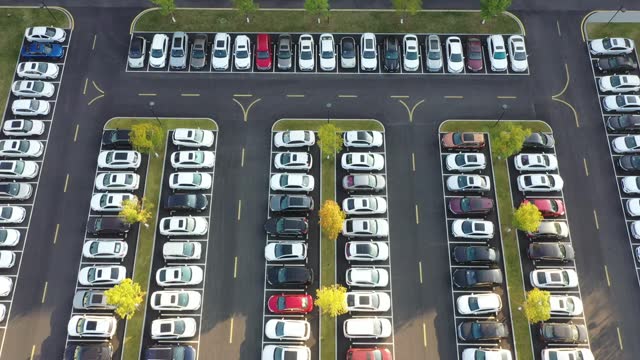 The parking lot is neatly filled with cars
