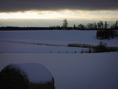 Scenic view of a snow covered field during evening