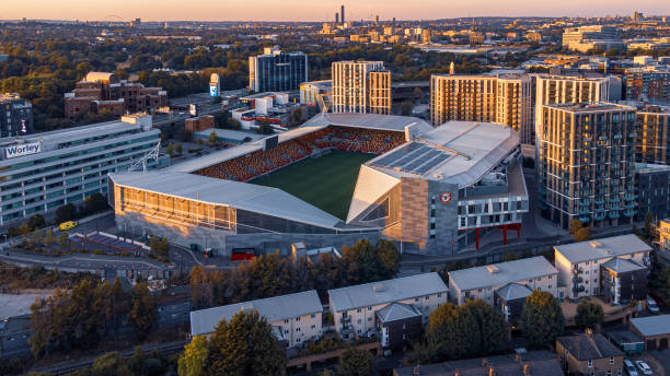 Aerial view of Gtech Community Stadium at sunset. London, UK London, United Kingdom – August 07, 2022: An aerial view of Gtech Community Stadium at sunset. London, UK english football stadium stock pictures, royalty-free photos & images