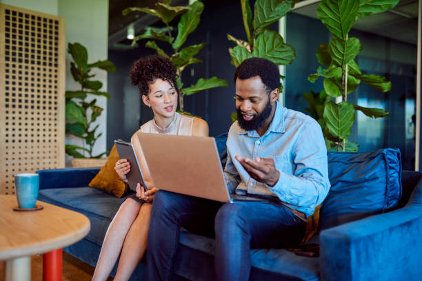istock Multiracial business people discussing proposal with digital devices in breakout space 1886852158