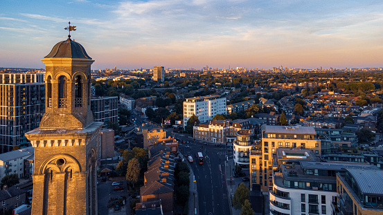 London, United Kingdom – August 07, 2022: An aerial view of a bustling cityscape of London at dusk with the Standpipe Tower in the foreground
