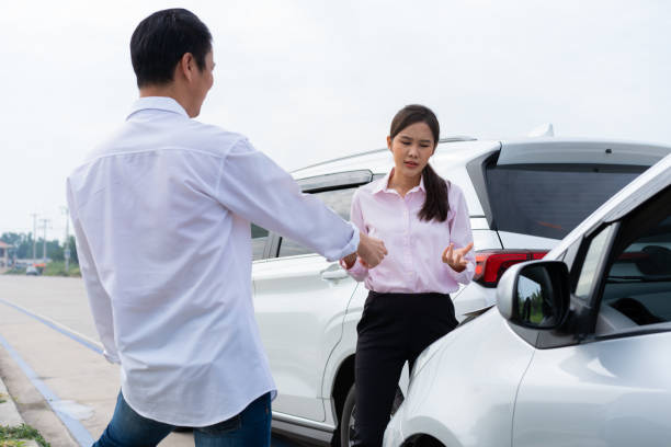 istock Two Drivers using a smartphone to exchange phone numbers and social media after a car accident. Concept of claim insurance for a car accident online after send photo and evidence to insurance company 1886852736