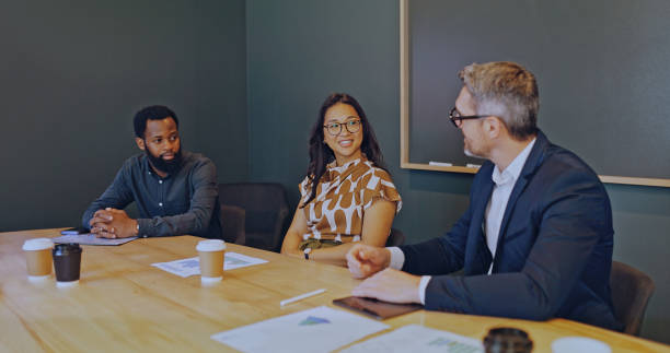 istock Multiracial business partners discussing partnership plans in boardroom 1886858635