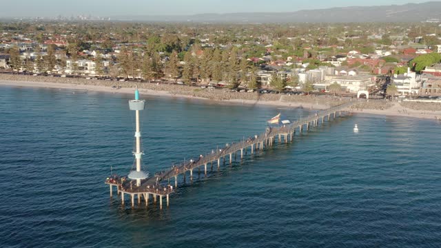 Aerial of Brighton beach jetty with Adelaide CBD in background, South Australia