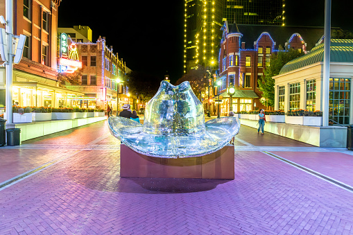 Fort Worth, Texas - November 5, 2023: people enjoy the illumination by night at sundance plaza with silver disco cowboy hat in downtown Fort Worth.