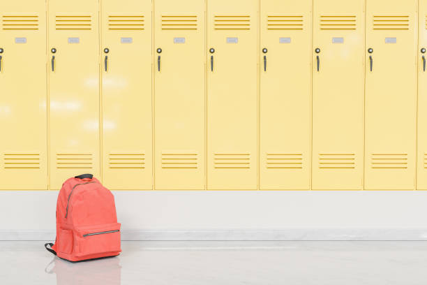 istock Red Backpack in Front of Yellow School Lockers, Education Concept. 1886884892