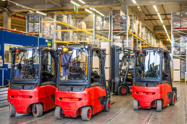 istock Forklift vehicles in warehouse with no people 1886894286