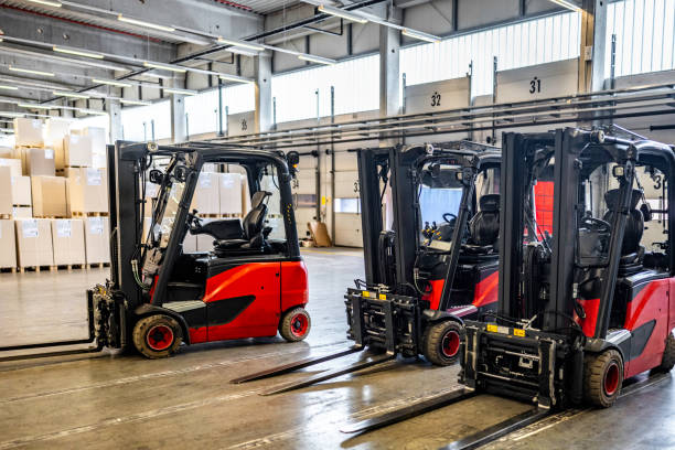 istock Forklift vehicles in warehouse with no people 1886894302