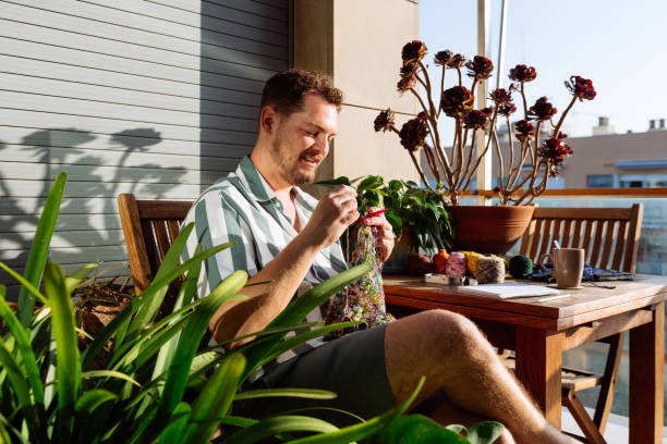 istock Bearded man with yarn on terrace 1886897434