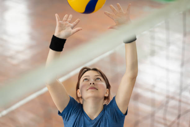 istock Young girl learning to play volleyball 1886901085