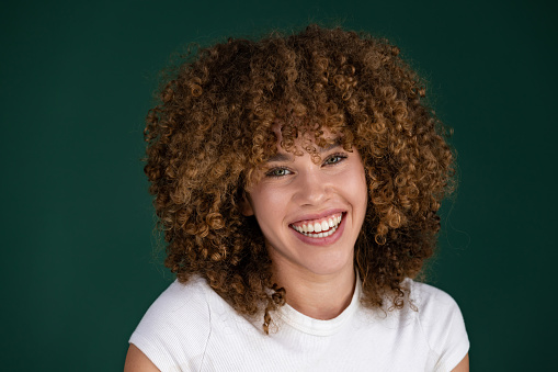 beautiful curly smiling girl posing in studio