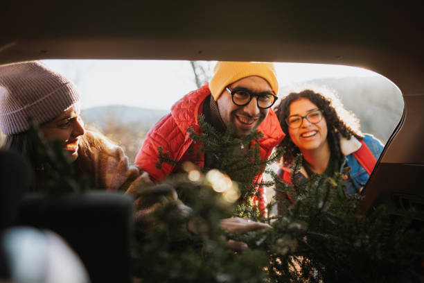 istock Putting up a Christmas tree in a car trunk 1886946906