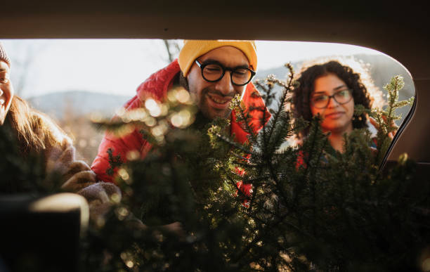 istock Putting up a Christmas tree in a car trunk 1886948494