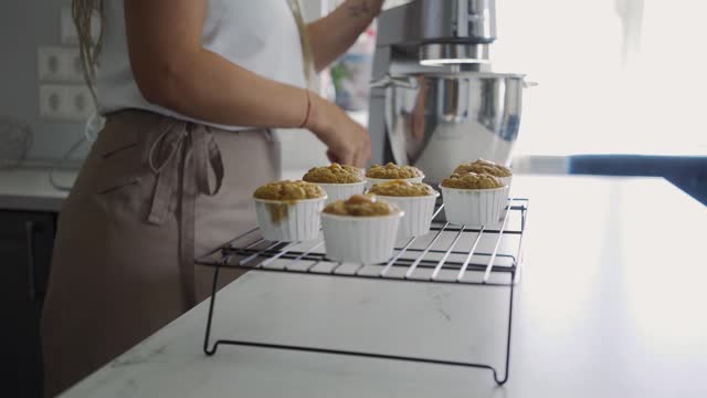 Close-up, woman prepare muffin with caramel