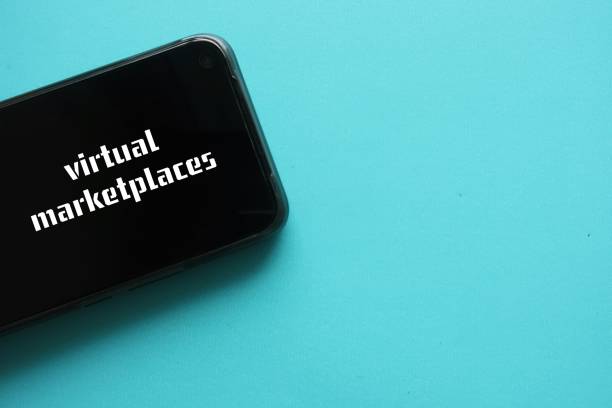 istock Mobile smartphone on copy space blue background with text on screen VIRTUAL MARKETPLACE - means e-commerce site that connects sellers with buyers or virtual store where individuals buy or sell products and services 1886959392
