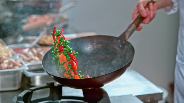 SLO MO Vegetables being tossed in the wok