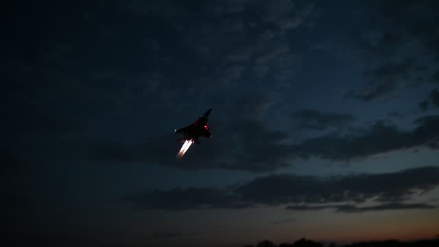 Military plane is flying at night