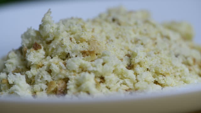 Pour breadcrumbs into a plate for breading.