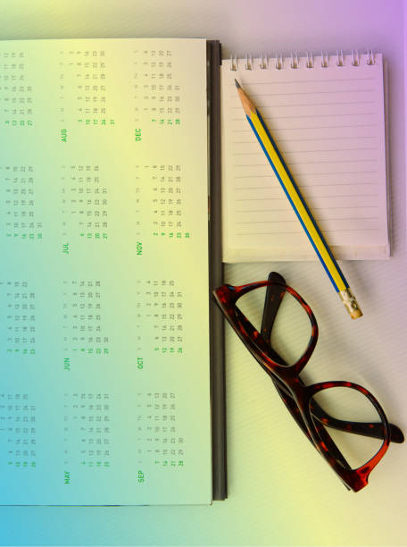 istock Desk calendar 12 months year 2025 with glasses notepad and pencil, object background 1886979797