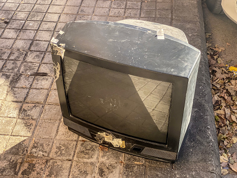 Obsolete CRT TV abandoned in the street