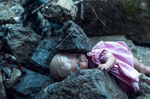 Doll on ruined building. Earthquake or war consequence.