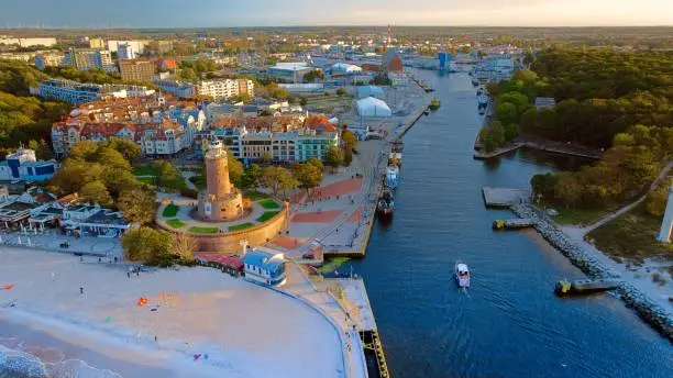 Port and lighthouse in Kolobrzeg, Poland. Photo taken with a drone at the beginning of autumn. The rippling, blue Baltic Sea.