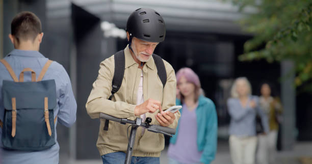 istock Man wearing helmet while checking his phone next to his e-scooter 1887021835