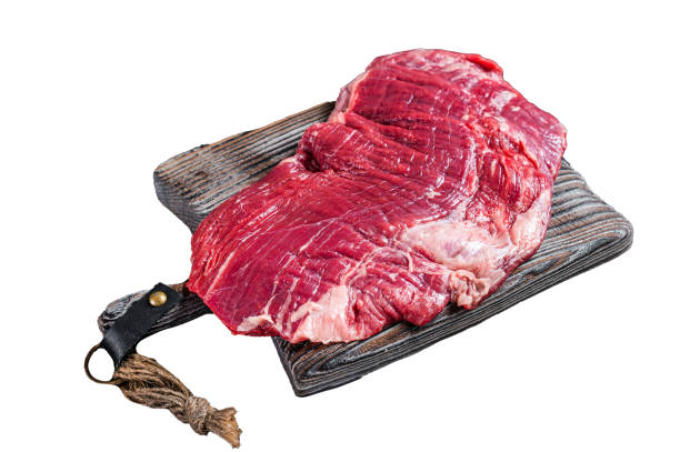 Uncooked Raw Flank or flap beef steak on butcher board.  Isolated on white background, top view.