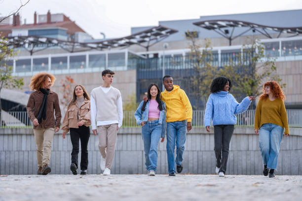 istock Friends walking confidently in a modern urban area. 1887066396