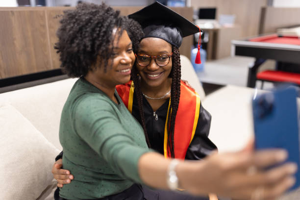 istock University graduation. Mother and daughter preparing 1887067966