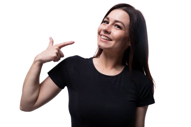 istock Young smiling european woman dressed in basic t-shirt pointing with finger 1887081051