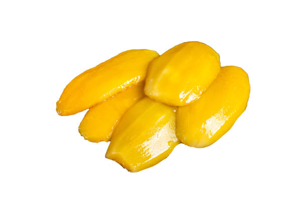 istock Preserve mango slices on a wooden board.  Isolated on white background, top view. 1887102144