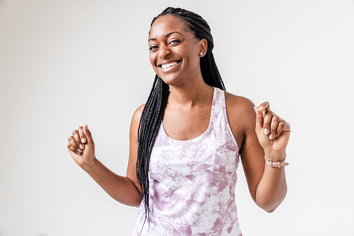 Portrait of a black woman in sports clothing, joy and positivity with a light dance