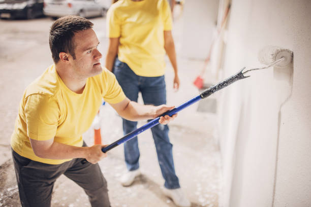 istock Man painting building wall 1887151176
