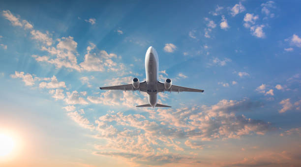 istock Airplane flying above tropical sea at sunset 1887156909