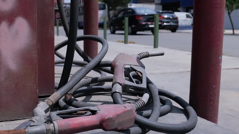 Old fuel station obsolete due to new advances in cars with green energy. City modern background