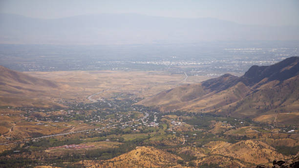 istock dry mountains and a small town in far 1887192751