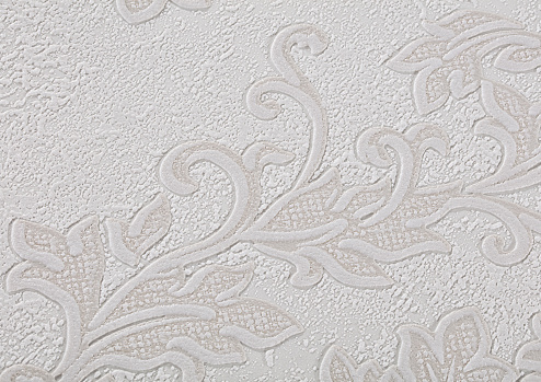 Background of light white paper wallpaper with a textured swirling pattern.