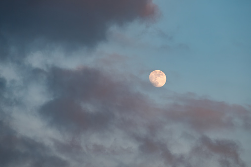 Full moon on cloudy day